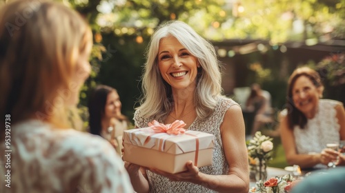 A woman is holding a gift box and smiling