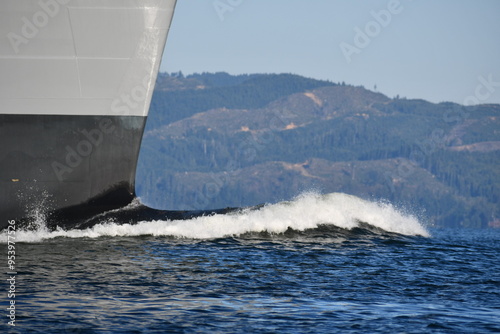 Large freighter bow cutting through the river. photo