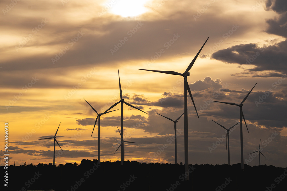 Wind turbines stand tall against a backdrop of cloudy skies, scattered across the expansive field. renewable energy. Wind turbines stand tall against a backdrop of cloudy skies, scattered across the expansive field. renewable energy.