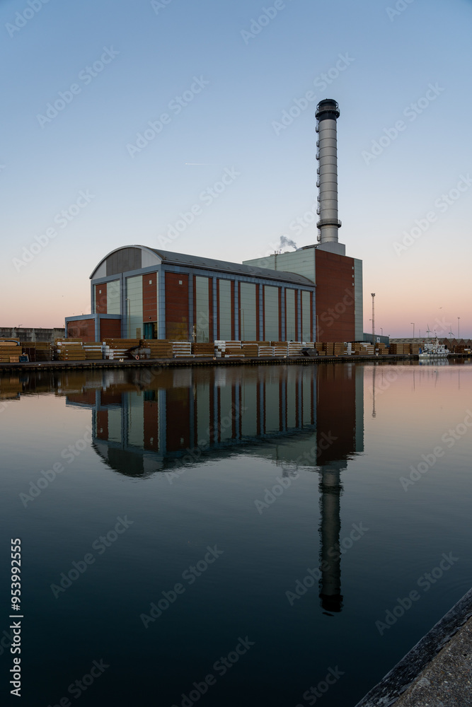 Naklejka premium Reflections of a gas fired power station at dawn.