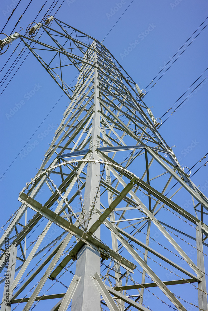 A tall metal electricity pylon under a clear blue sky. A tall metal electricity pylon under a clear blue sky.