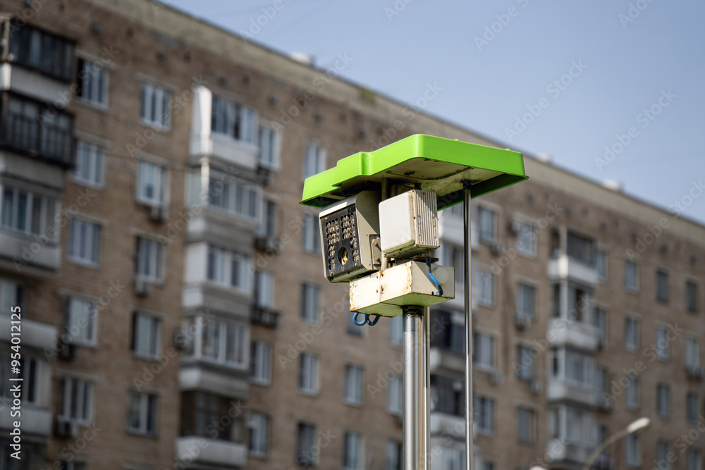 speed control camera emerges from a specialized vehicle, integrated into an urban landscape, highlighting modern surveillance technology in city traffic management