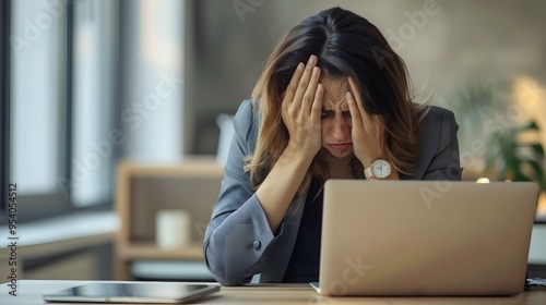 Young sad businesswoman is sitting at table covering