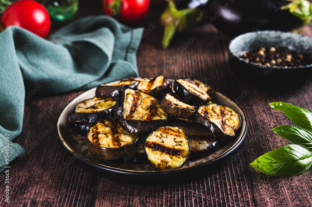 Appetizing spicy grilled eggplant pieces on a plate on the table