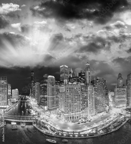 Black and white aerial view of Chicago skyline along Chicago River on a summer night