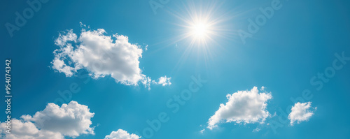 The sky is blue with a few clouds and the sun is shining brightly