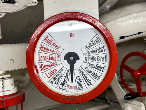 Engine order telegraph or Chadburn, communication device on a German submarine from the bridge to the engine room in bright red with gauge, dial and German text, for engine control photo