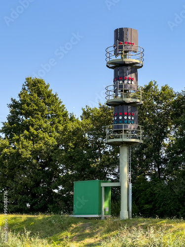 Signal mast with indicators, lights, for passing ships guidance through the Kiel canal, nord-ostsee kanal through Germany from North Sea to Baltic Sea. photo