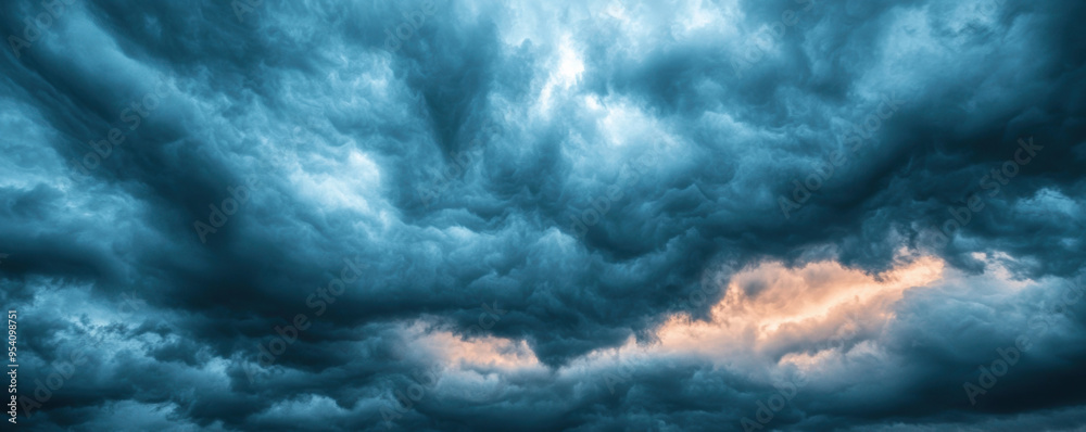 Fototapeta premium Dark clouds with the sun breaking through, stormy weather, dramatic lighting