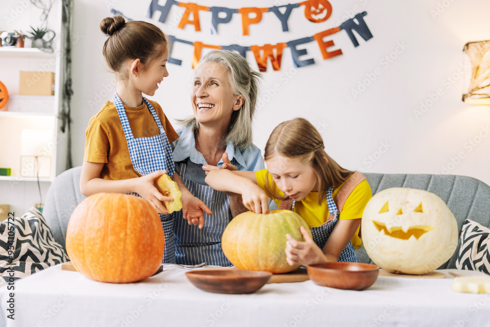 Fototapeta premium Grandmother and granddaughters carving pumpkins for halloween party, creative, hand made concept