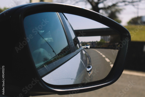 Rearview Mirror Reflection: Cars on a Busy Road
