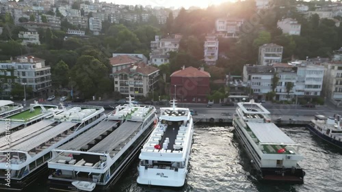 Drone view a large ship against a coastline with beautiful tiny houses moving at low speed in the Aegean Sea and Marmara Sea Istanbul, Turkey. High quality footage in 4K
