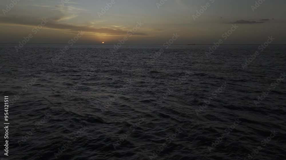 Drone flies toward a fading sunset over choppy waters Drone flies toward a fading sunset over choppy waters