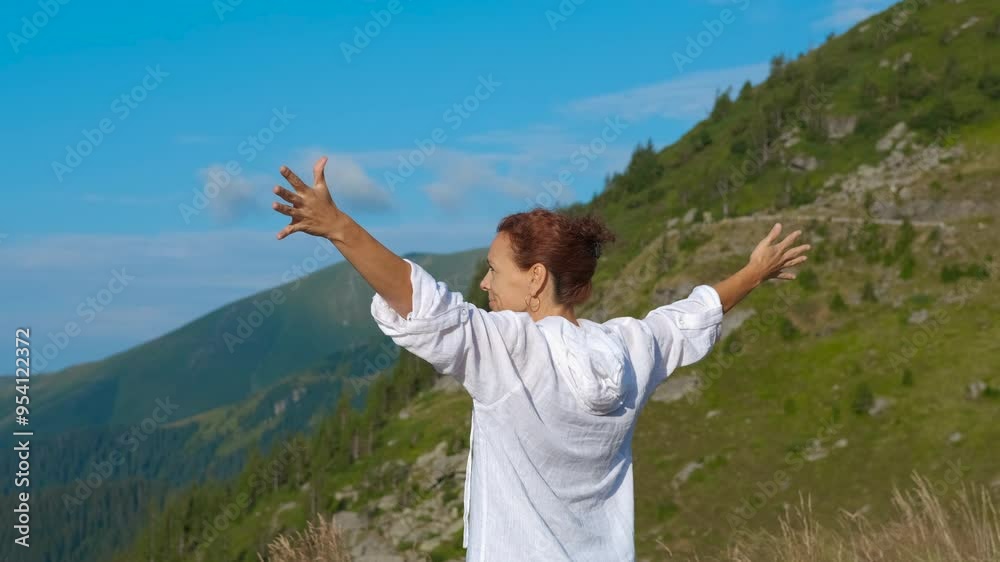 Female with open hands against mountains. A female with open hands relax on the top of the hill against fields. Female with open hands against mountains. A female with open hands relax on the top of the hill against fields.