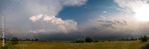 Large clouds over a field