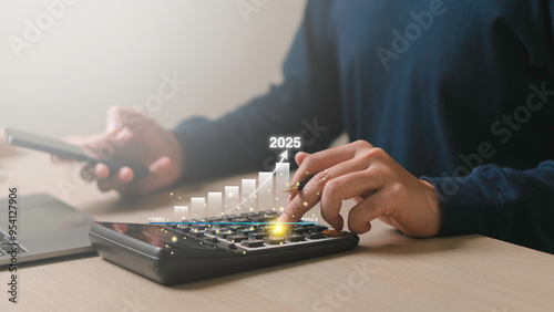 Obraz na płótnie Businessman analyzes business goals and growth in 2025, strategy digital marketing, profit income, economy, stock market trends and business, technical analysis strategy. w salonie