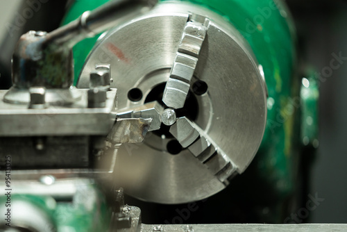 An old, well-used lathe machine in a workshop, a vital tool for metalworking and precision engineering tasks. photo