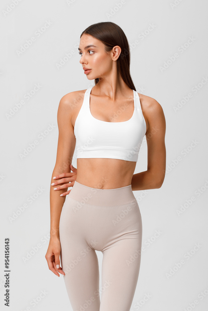 Fototapeta premium Fitness woman. Athletic girl on the gray background