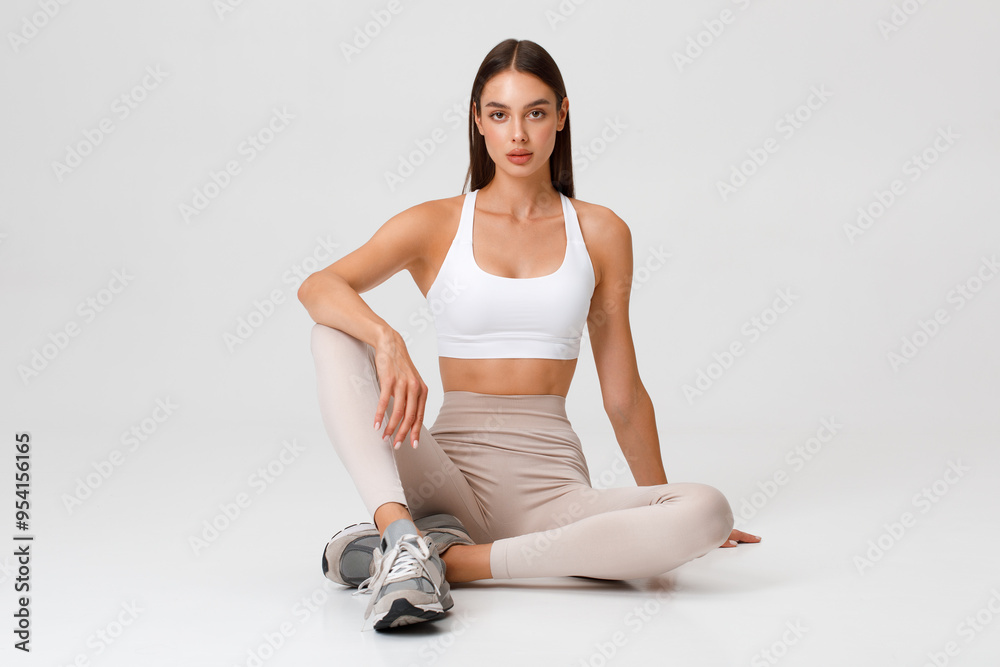 Fitness woman. Athletic girl on the gray background Fitness woman. Athletic girl on the gray background
