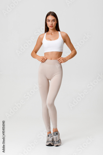 Fitness woman. Athletic girl on the gray background