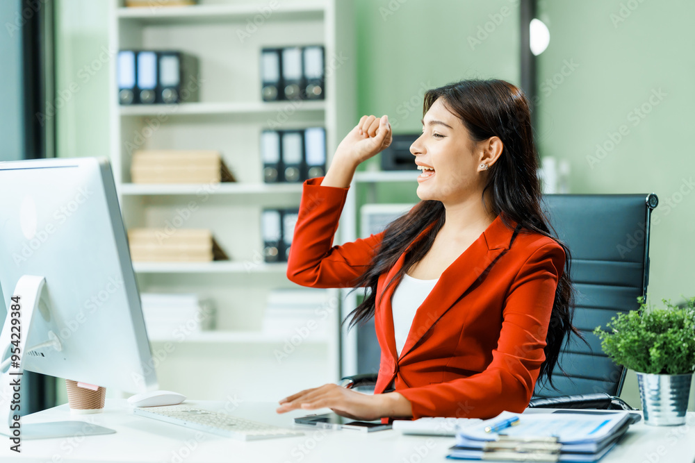Obraz premium young Asian businesswoman in a formal suit works at her desk in a modern glass office, consulting on LGBTQ-inclusive strategies across various business domains, including HR, IT, and marketing.