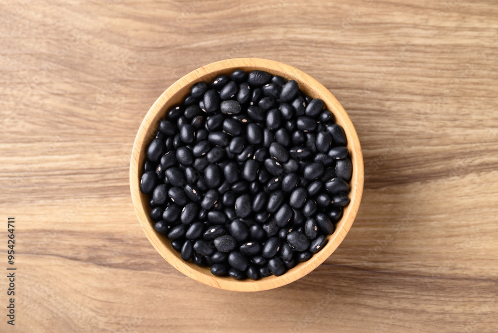 Black bean in bowl on wooden background, Table top view