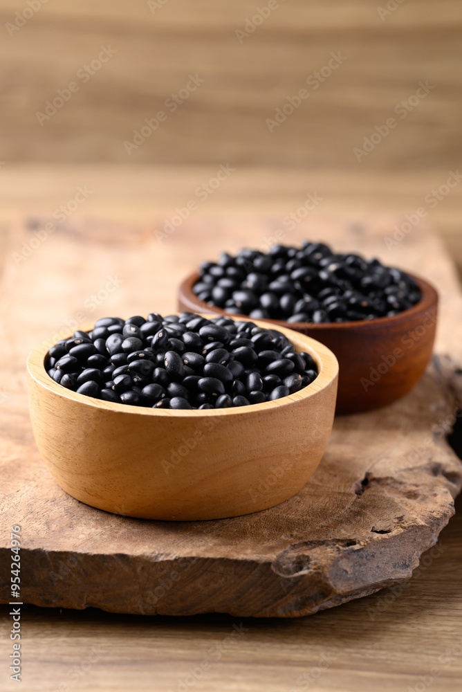 Black bean in bowl on wooden background, Food ingredient Black bean in bowl on wooden background, Food ingredient