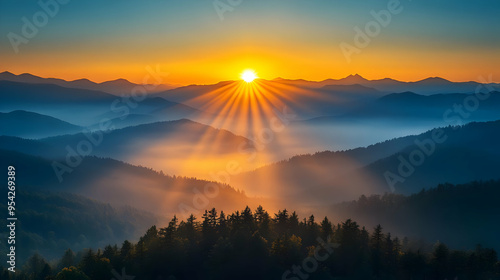 Sunrise over a mountain range with layers of fog and trees.