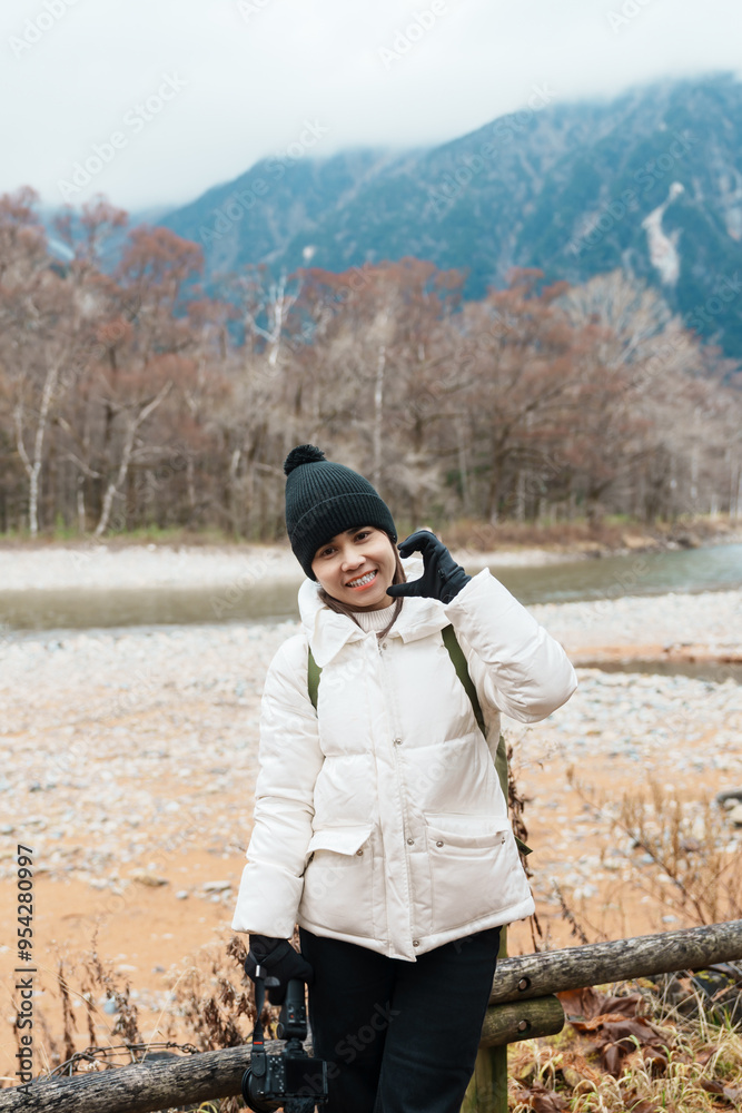 Woman tourist travel Kamikochi National Park, happy Traveler sightseeing Azusa river with mountain, Nagano Prefecture, Japan. Landmark for tourists attraction. Japan Travel, Destination and Vacation Woman tourist travel Kamikochi National Park, happy Traveler sightseeing Azusa river with mountain, Nagano Prefecture, Japan. Landmark for tourists attraction. Japan Travel, Destination and Vacation