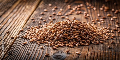 Glistening brown hanjeli seeds on rustic wooden table against earthy background photo