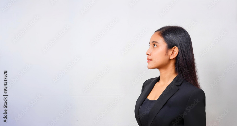 A Southeast Asian woman in a side profile, dressed in business attire. A Southeast Asian woman in a side profile, dressed in business attire.