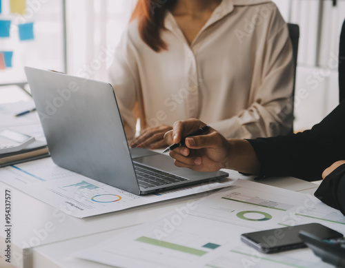 Financial analysts analyze business financial reports on a digital tablet planning investment project during a discussion at a meeting of corporate showing the results of their successful teamwork.