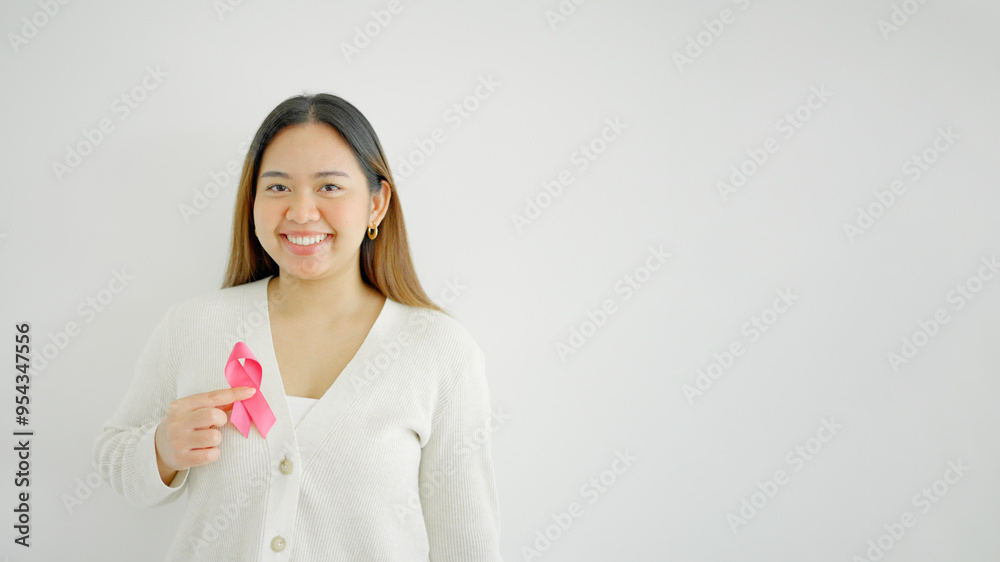 multiethnic young woman with pink ribbons, breast cancer awareness, October pink, world cancer day concept multiethnic young woman with pink ribbons, breast cancer awareness, October pink, world cancer day concept