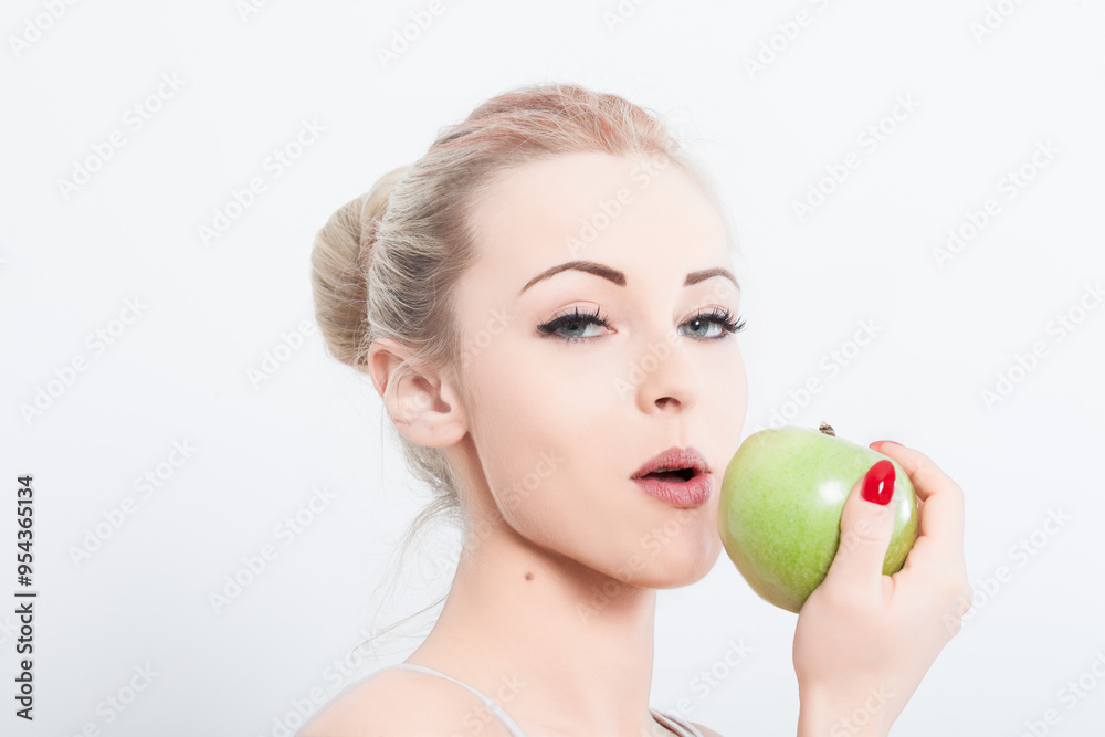 Attractive young woman eating green apple on white background Attractive young woman eating green apple on white background