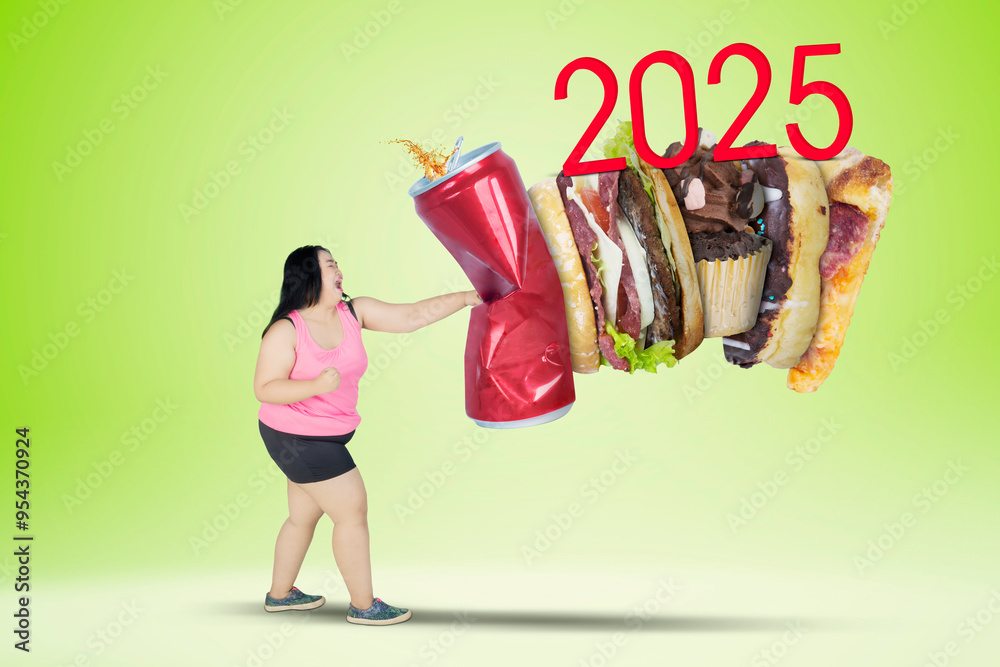 Φωτογραφία Picture of fat woman punching soft drink and fast food with number 2025 in the studio