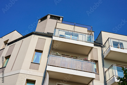 Multi story apartment building exterior. Residential building facade with balconies at summer day. Modern residential architecture in European city