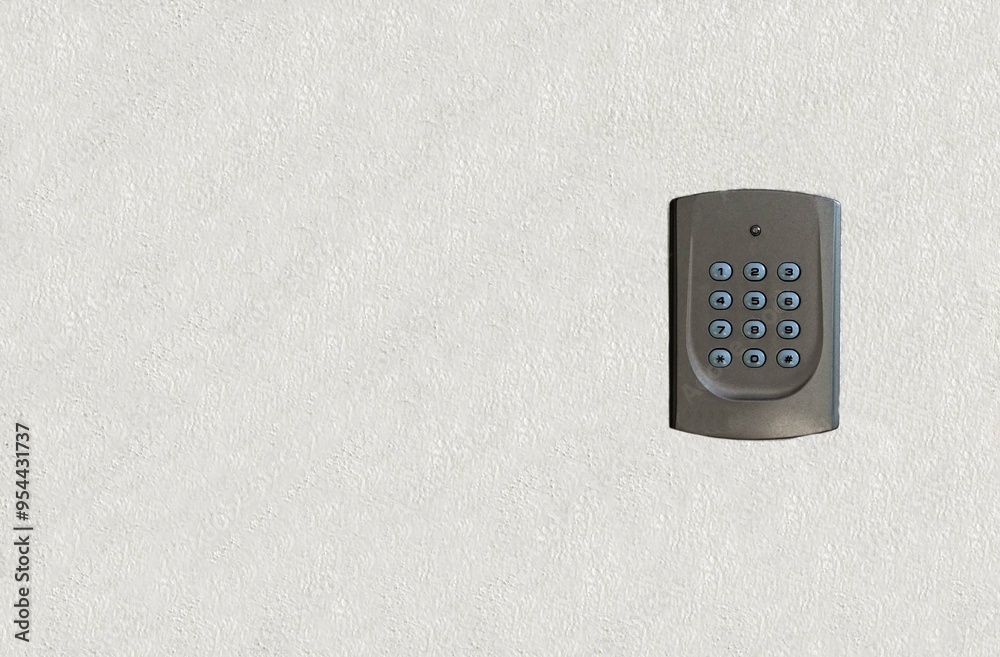A key pad attached the wall for security the entry door. A key pad attached the wall for security the entry door.