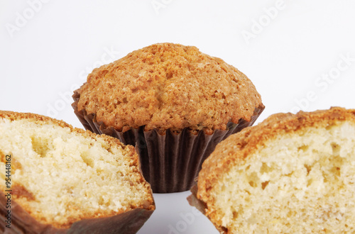 Whole and half muffin on a white background.