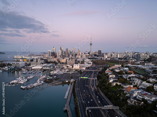 Auckland, New Zealand: Dramatic aerial view of the Westhaven highway leading to Auckland downtown district skyline at sunset in New Zealand.