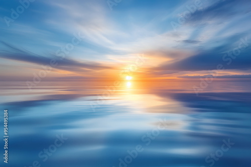 Tranquil sunset over a calm ocean with reflections of the sun and clouds in the water