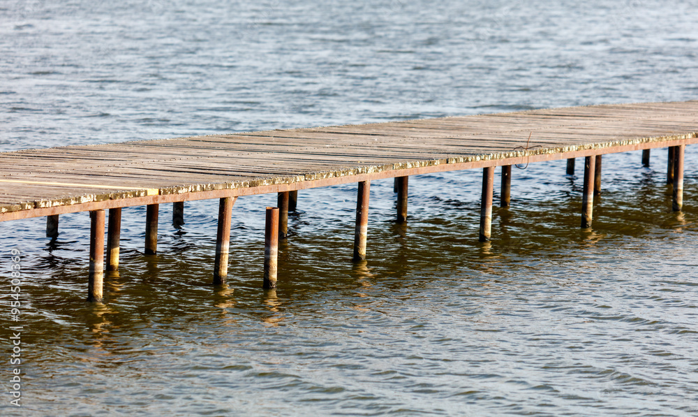 Wooden bridge on the lake in summer Wooden bridge on the lake in summer