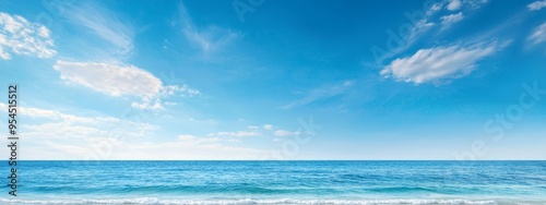 Ocean with a blue sky, dotted by clouds