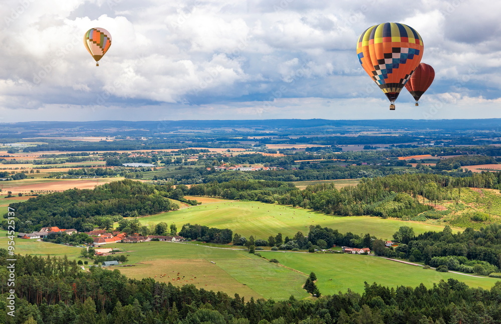 Obraz premium Hot air balloons fly over European landscape