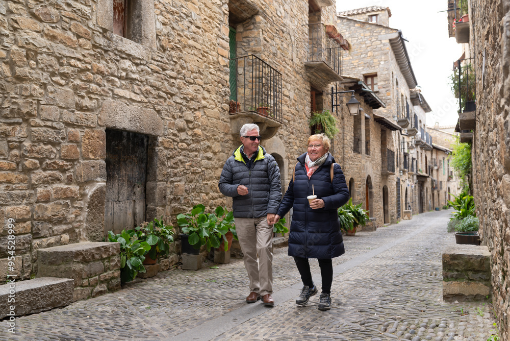 Senior couple visiting Ainsa, one of the beautiful villages of Spain. Senior couple visiting Ainsa, one of the beautiful villages of Spain.