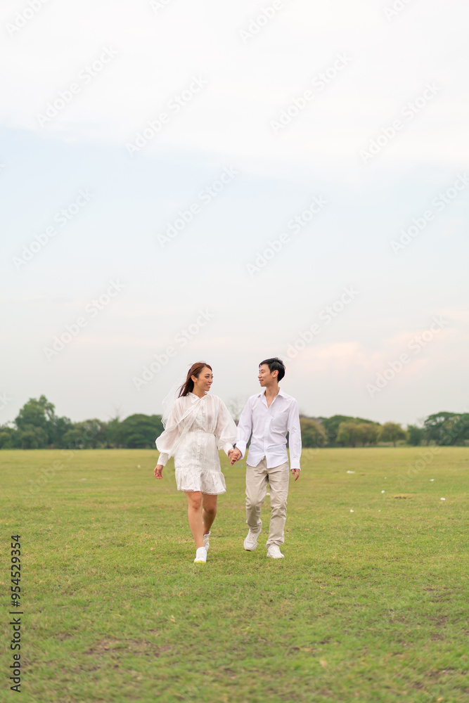 Happy young Asian couple in bride and groom clothing Happy young Asian couple in bride and groom clothing