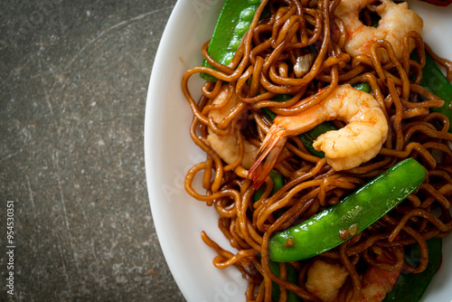 stir-fried yakisoba noodles with green peas and shrimps photo