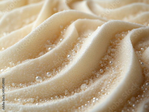 Close-up of creamy vanilla frosting with soft waves and sparkling sugar crystals, perfect for dessert decoration and culinary artistry. photo