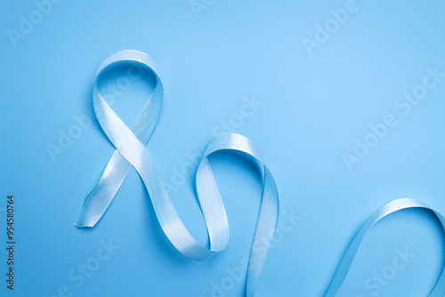 Blue ribbon on blue background for world diabetes day or prostate cancer awareness month