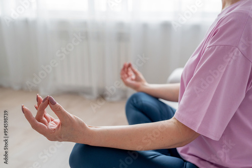 Wallpaper Mural Elderly lady does yoga on the sofa in modern living room, enhancing mental and physical wellbeing Torontodigital.ca