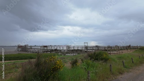 Cabins at end of piers along Loire River in France photo